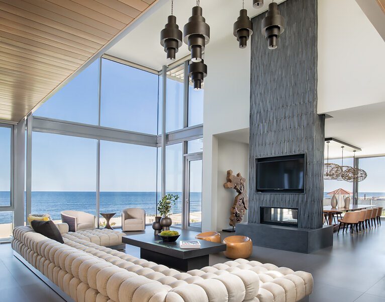 A modern living room with a view of the ocean.