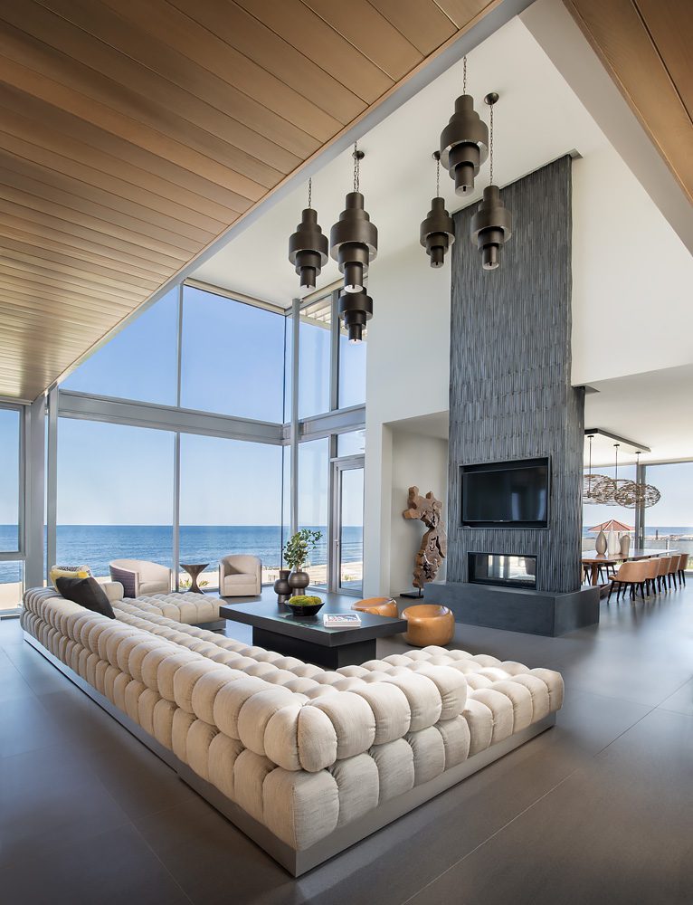 A modern living room with a view of the ocean.