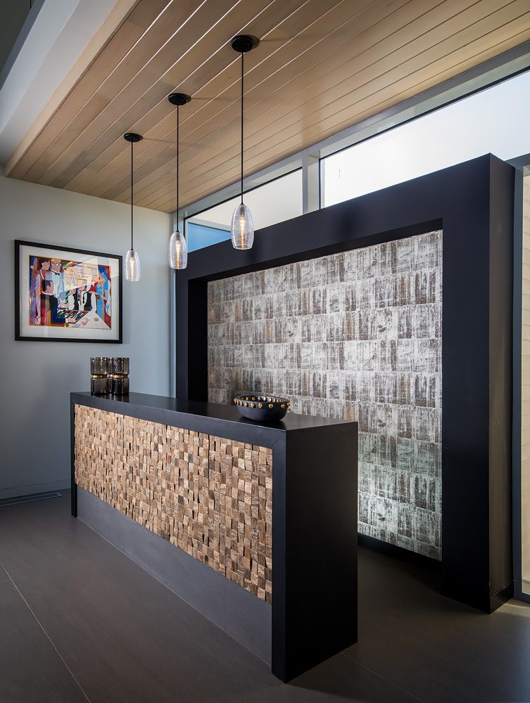 A modern office with a wooden reception desk.