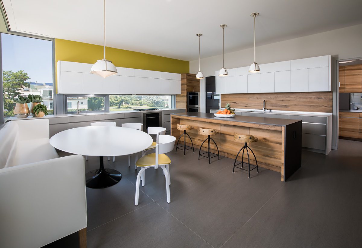 A kitchen with a table and chairs.