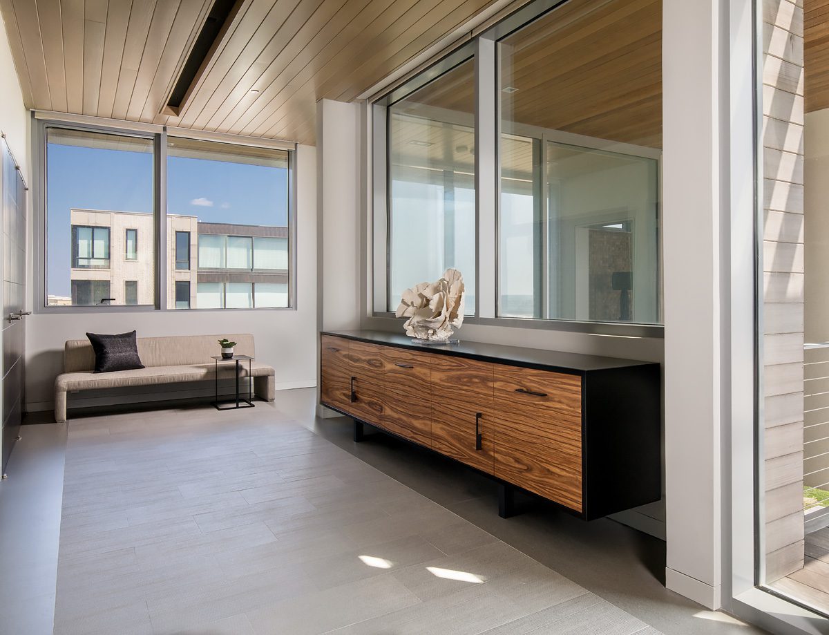 A living room with a large window overlooking a balcony.