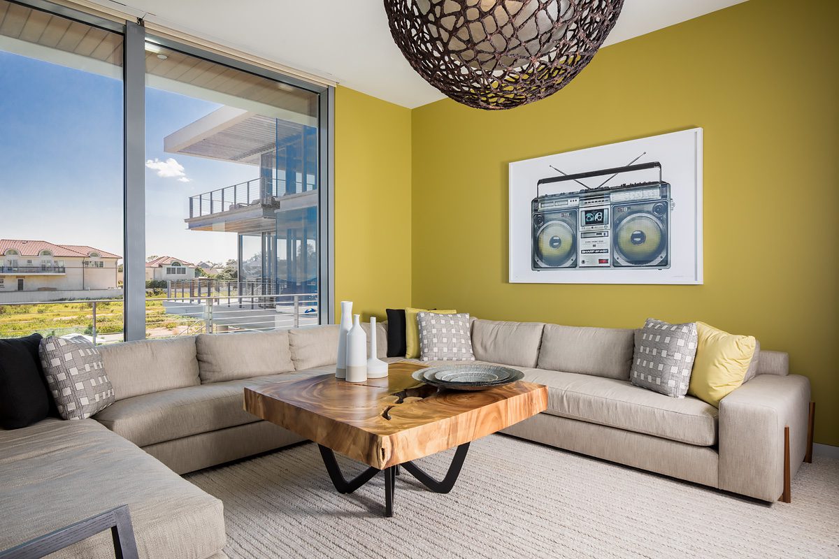 A living room with yellow walls and furniture.