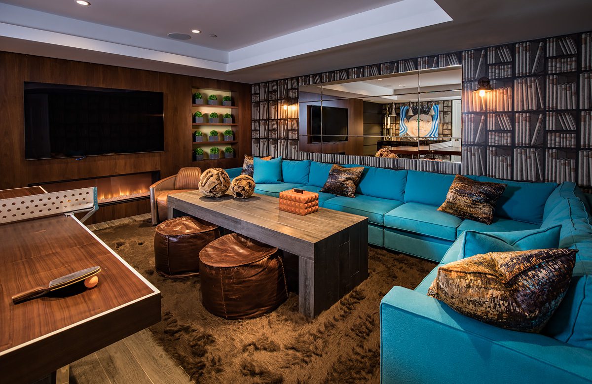 A living room with blue couches and a tv.