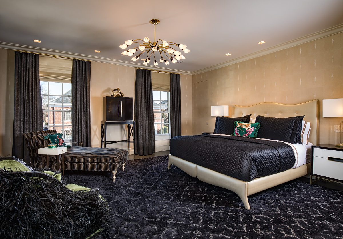 A bed in a bedroom with a chandelier.