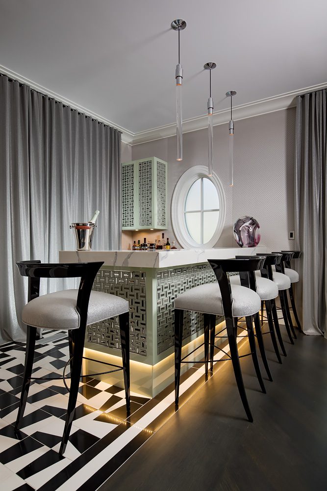 A black and white kitchen with a round table and chairs.