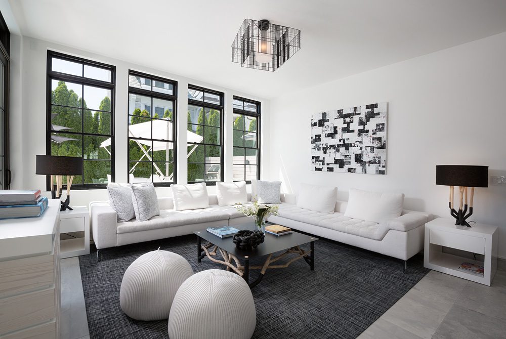 A living room with white couches and a coffee table.