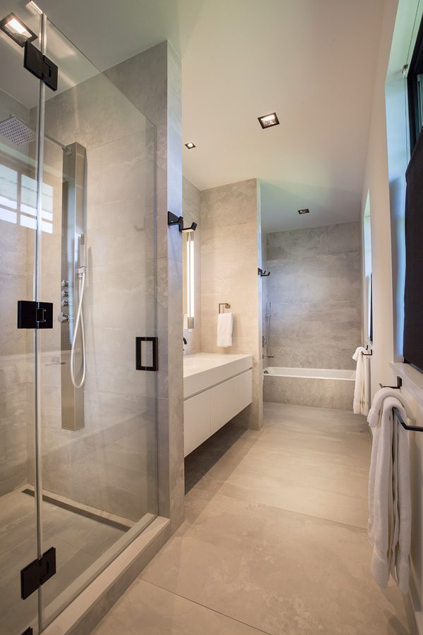 A bathroom with a glass shower door.