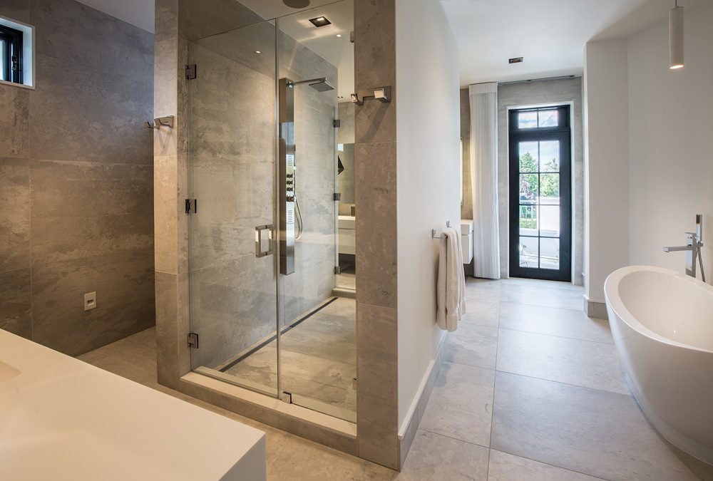 A modern bathroom with a glass shower stall.