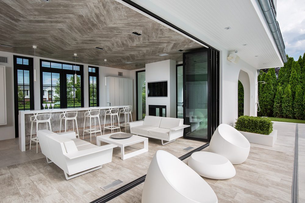 A modern outdoor living area with white furniture.