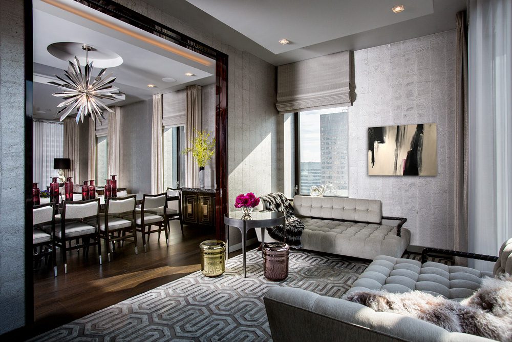 A modern living room with a large chandelier.